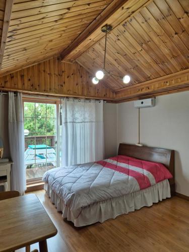 a bedroom with a bed and a wooden ceiling at Ganghwa Sweet House Pension in Incheon