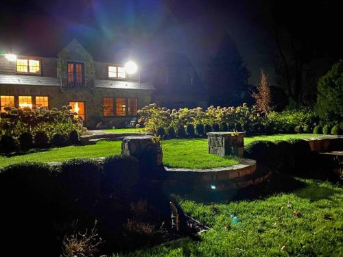 a house at night with a yard with a pond at Historic Middleburg Equestrian Estate in Middleburg