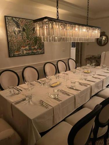 a dining room with a long table with white tables and chairs at Historic Middleburg Equestrian Estate in Middleburg