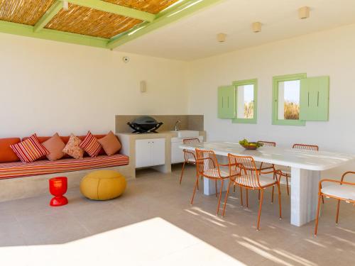 a kitchen and living room with a table and chairs at Plioni Villas With Private Pool & Suites With Hot Tub in Mikri Vigla
