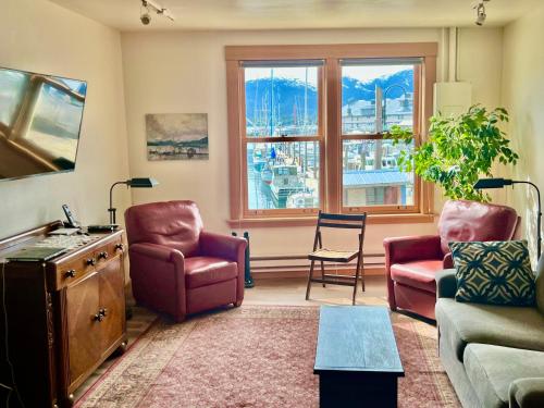 a living room with a couch and chairs and a window at Inn At Creek Street in Ketchikan