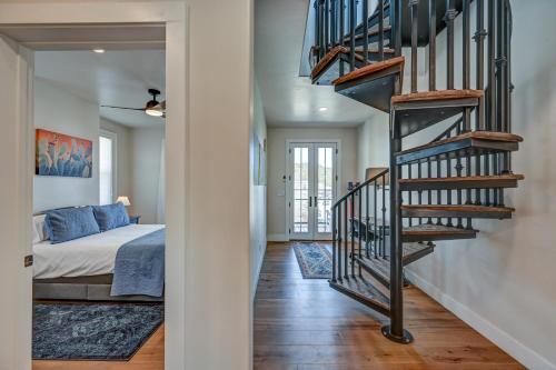 a bedroom with a bed and a spiral staircase at South Main Residences by Surf Hotel in Buena Vista
