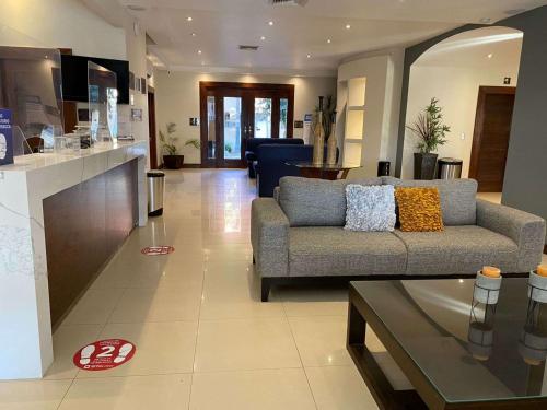 a living room with a couch and a table at Best Western Plus Chihuahua Aeropuerto in Chihuahua
