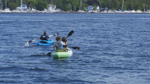 a group of people and a dog on a raft in the water at Country House Resort in Sister Bay