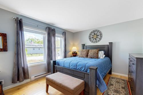 a bedroom with a bed and a clock on the wall at Electric Mountain in West Townshend