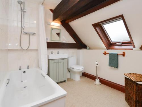 a bathroom with a sink toilet and a window at 1 Bed in Lyme Regis 90145 in Lyme Regis