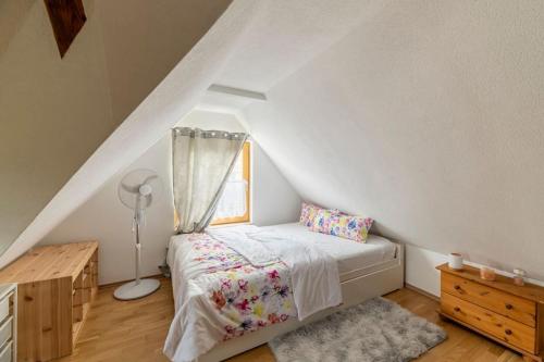 a small bedroom with a bed and a window at Idyllic holiday home - relaxation place in Leibnitz