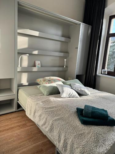 a bed in a bedroom with a large headboard at Gäste-Appartements Morgensonne & Sonnenschein in Dresden