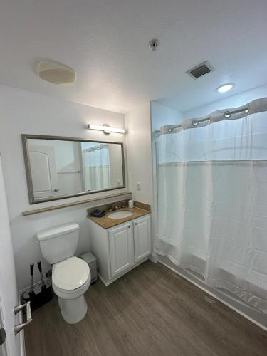 a bathroom with a toilet and a sink and a shower at Orlando 3rd Floor - Blue Heron in Orlando