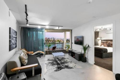 sala de estar con sofá y cama en Spacious River view 3 Bdrm Apt with 2 Car spaces en Brisbane