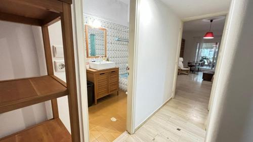 a view of a bathroom with a sink and a mirror at Cozy home in Kypseli in Athens