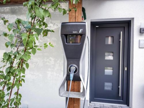 a parking meter sitting in front of a door at Lodge Elise in Vorderkrimml
