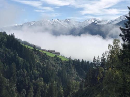 a view of a mountain with fog in the valley at Bella Vista S in Vorderwaldberg