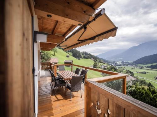 a wooden deck with a table and chairs on it at Bella Vista XL in Vorderwaldberg