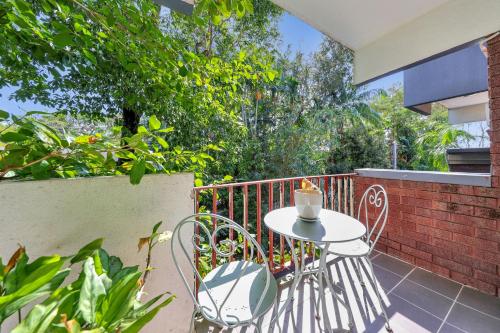 a small table and chairs on a balcony at Paravista Motel in Darwin