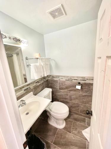 a bathroom with a toilet and a sink at Royal Lodge in Coalinga