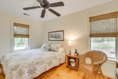 a bedroom with a bed and a ceiling fan at Charming Lawley Cottage: Deck, Fire Pit & Yard! in Lawley