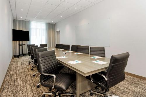 a conference room with a large wooden table and chairs at Staybridge Suites Winter Haven - Auburndale in Winter Haven