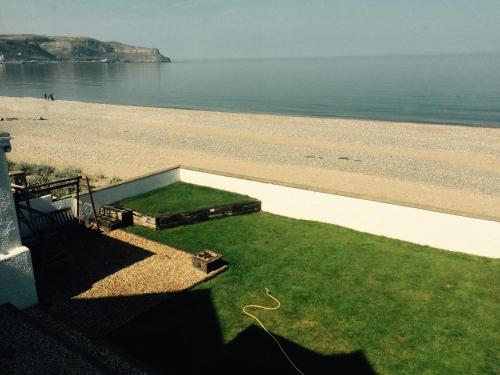 a view of the beach from a balcony of a house at Superb Cintra Beachside Apartments in Llandudno