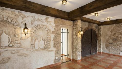 a hallway with a stone wall with a door at Hotel Rebstock in Baden-Baden