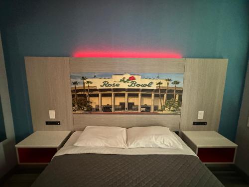 a bedroom with a bed with a sign above it at Lincoln Motel - Los Angeles, Hollywood Area in Pasadena