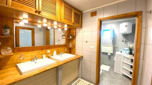 a bathroom with two sinks and a mirror at Family friendly house with a swimming pool Krmed, Central Istria - Sredisnja Istra - 23175 in Bale