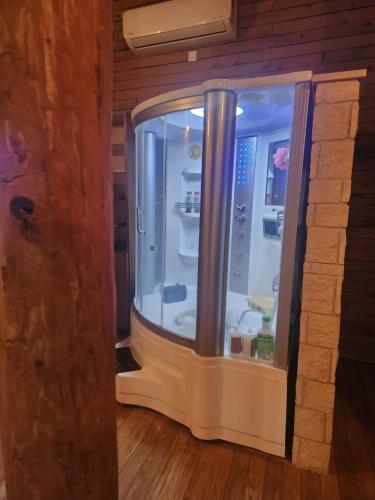 a refrigerator in a room with a brick wall at La Hacienda Cyprus in Limassol