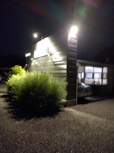 a house lit up at night with a street light at Murray Bridge Motor Inn in Murray Bridge