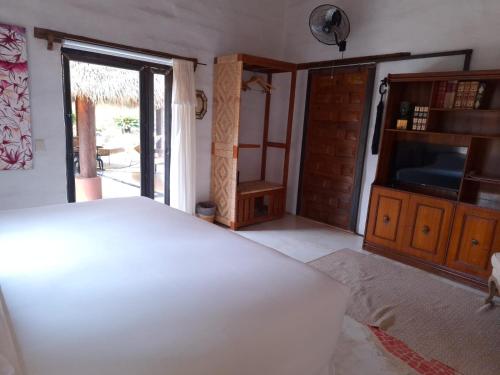 a bedroom with a bed and a sliding glass door at Quinta Ascensión Hotel Boutique Only Adults in Malinalco