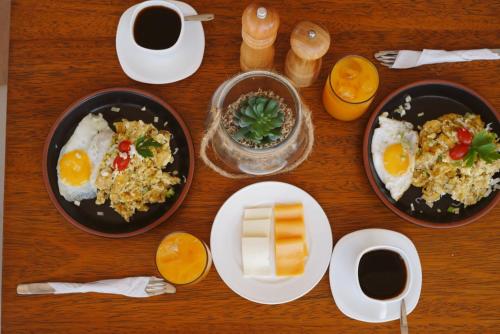 a table with plates of food and cups of coffee at Hotel Presidente Beach Playas in Playas