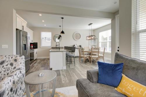 a living room and kitchen with a couch and a table at The Sand's Ours, Just Say When in Ocean Shores