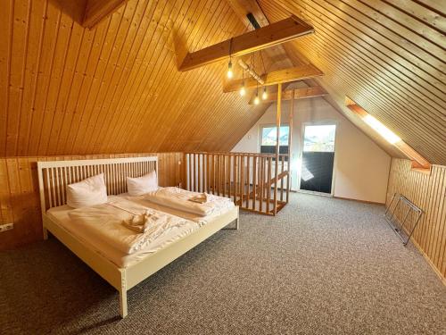a bedroom with a bed in a wooden room at ETW Hausberg 45 - Fr Schwenn in Sassnitz