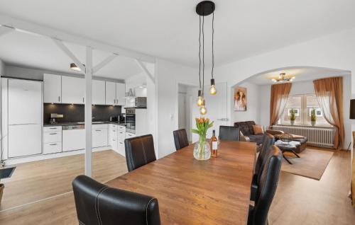 a dining room and living room with a table and chairs at Küstenkind in Wilhelmshaven