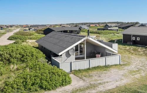 an aerial view of a small house in a field at Holiday Home Hvide Sande 40 in Bjerregård