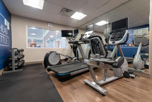 a gym with treadmills and machines in a room at Holiday Inn Express Hotel & Suites Hampton South-Seabrook by IHG in Seabrook