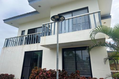 a white house with a street light in front of it at Lover's Point Beach Front Resort in Lian