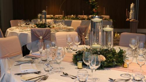 a group of tables with wine glasses on them at voco Leicester by IHG in Leicester