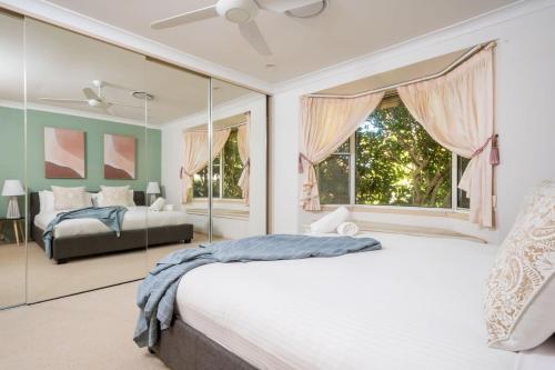 a bedroom with a bed and a large window at Waterfront Retreat with Private Dock-Isle of Capri in Gold Coast