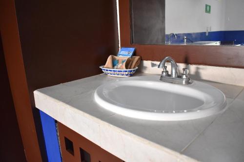 a bathroom with a white sink and a mirror at Hotel Plaza Almendros, Isla Mujeres in Isla Mujeres