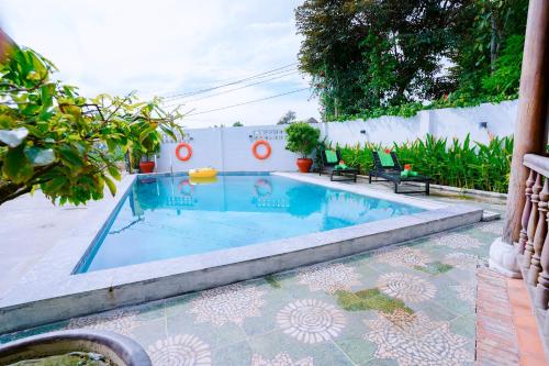 a swimming pool with blue water in a house at Tra Que Green Villa Hoi An in Hoi An