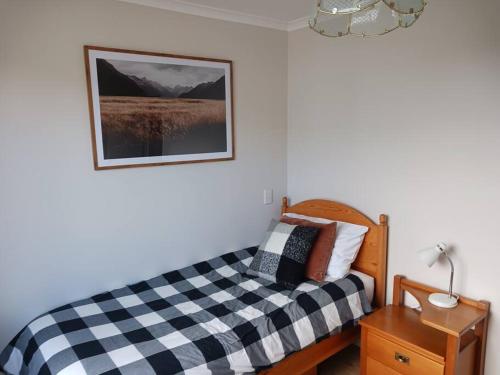a bedroom with a black and white checkered bed at Charming House in Westport in Westport