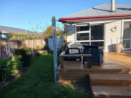 a wooden deck with a table and chairs on it at Charming House in Westport in Westport