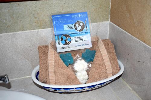 a book sitting on top of a bathroom sink at Hotel Plaza Almendros, Isla Mujeres in Isla Mujeres