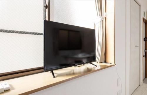 a flat screen tv sitting on a window sill at Masaya setagaya in Tokyo