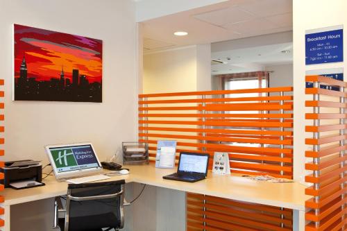 an office with two laptop computers on a desk at Holiday Inn Express Reggio Emilia by IHG in Reggio Emilia