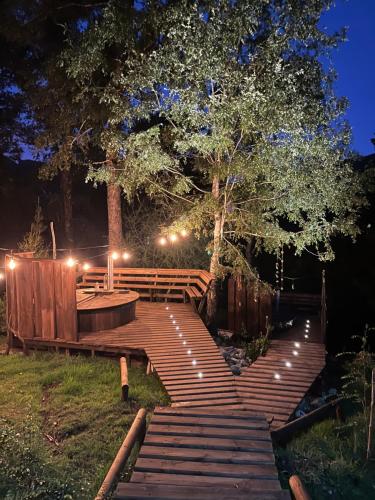 a deck with stairs and lights at night at Wincarayen Lodge & Cabañas in Panguipulli