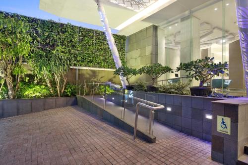 a lobby of a building with plants on the wall at Holiday Inn Express Jakarta Wahid Hasyim by IHG in Jakarta