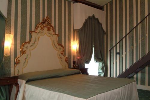 a bedroom with a bed in a room with stairs at Hotel Belle Epoque in Venice