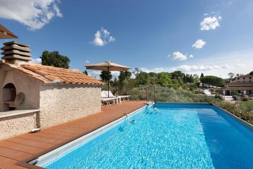 a villa with a swimming pool and a wooden deck at A Casa di Franca Villa con piscina in Gambassi Terme