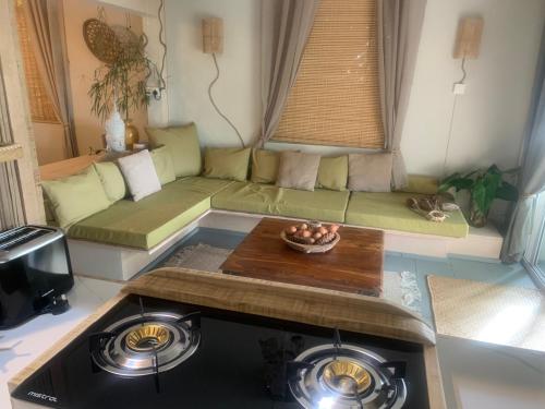 a living room with a couch and a table at The Palms Ocean views in Rodrigues Island
